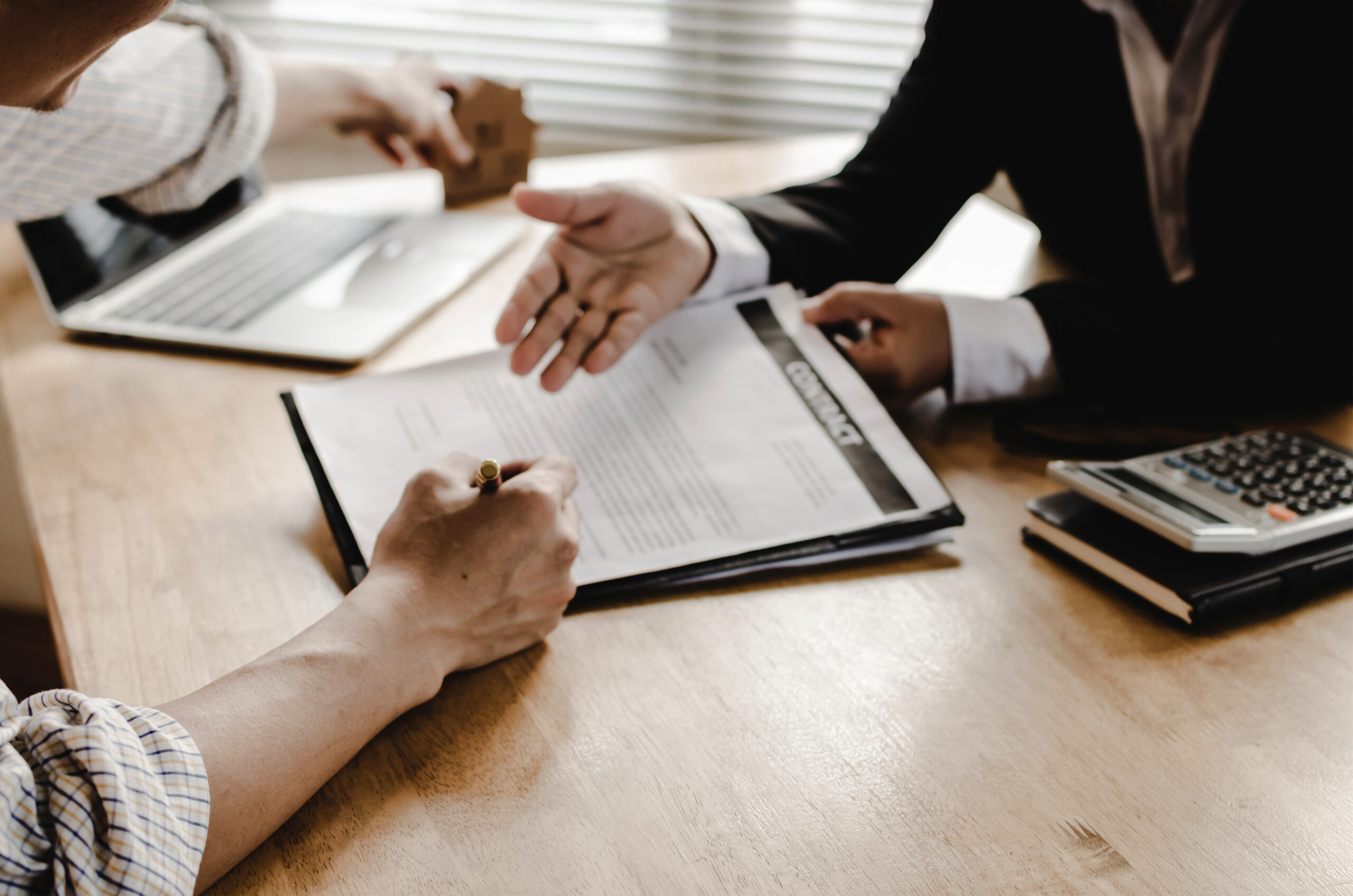 Client signing real estate loan contract - CW Funding real estate loans
